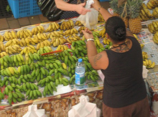 Produce Vendor with a large tattoo.